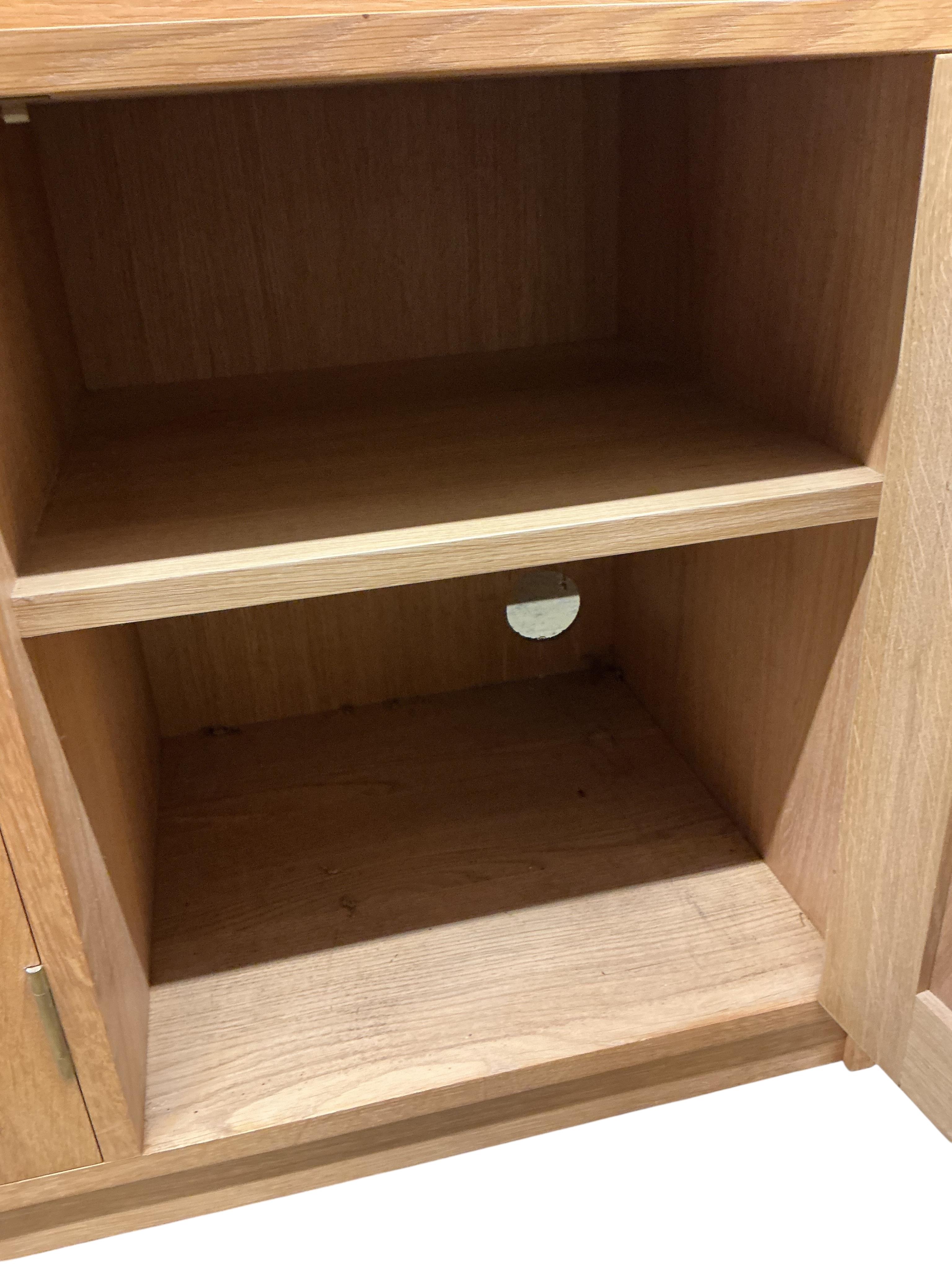 A Contemporary bespoke oak open bookcase, cupboards below, width 141cm, depth 46cm, height 169cm